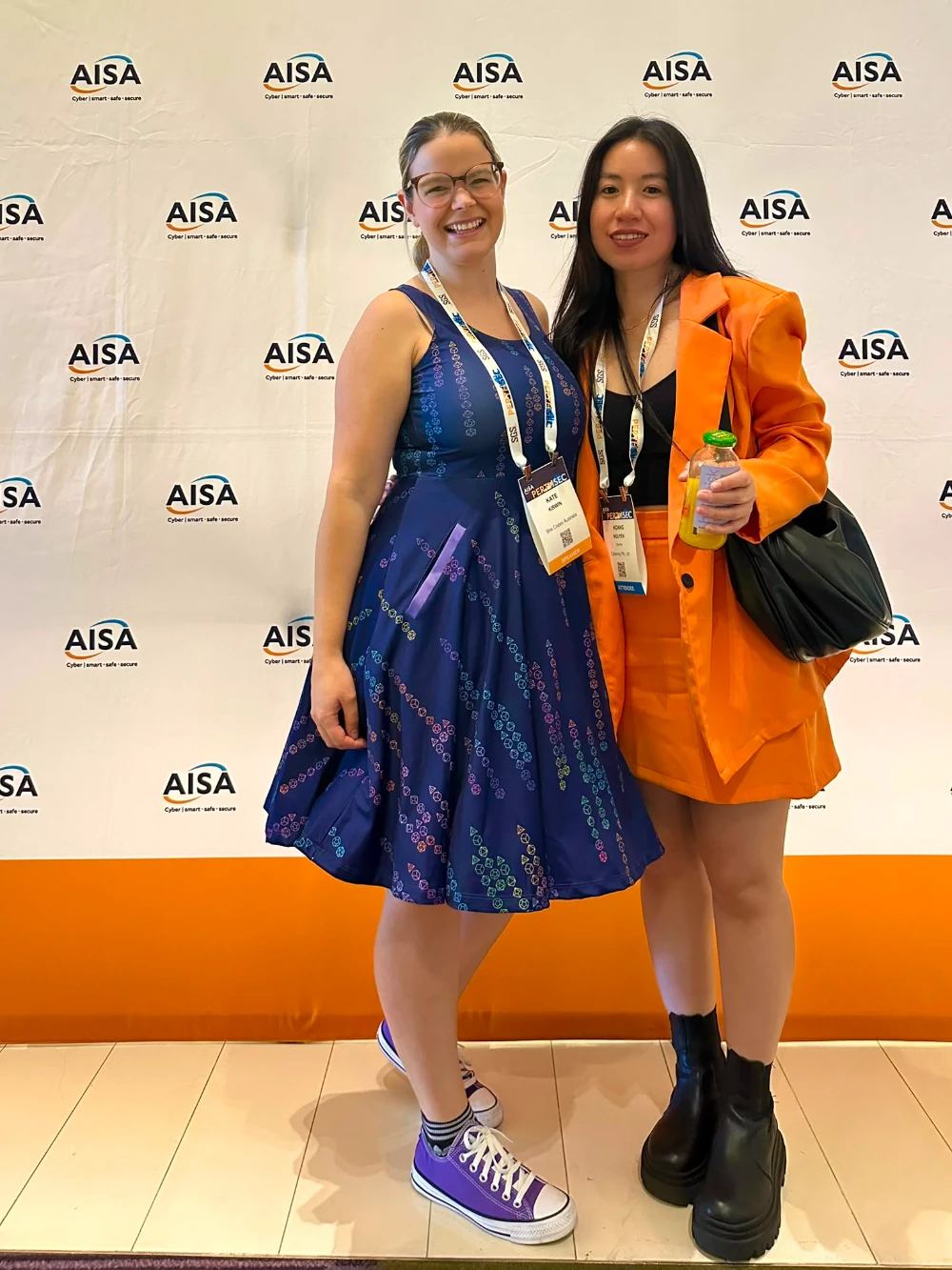 Hoang Nguyen from CyberNIQ with speaker Kate Kirwin at the AISA backdrop
