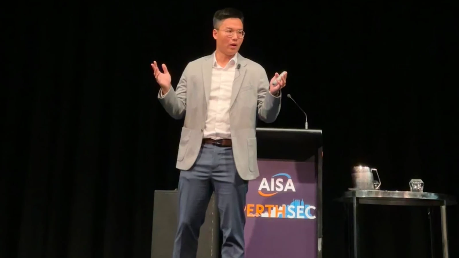 Huu Nguyen presenting on stage at AISA PerthSec 2024, Crown Perth
