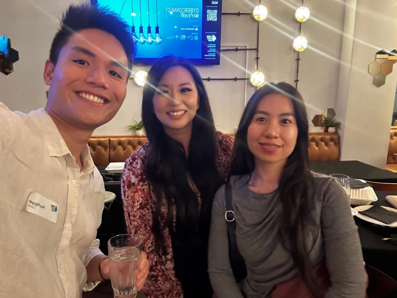 Huu and Uyen from CyberNIQ with an attendee at CyberConnect