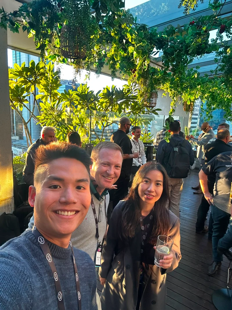 Huu and Uyen from CyberNIQ with a vendor representative on the rooftop